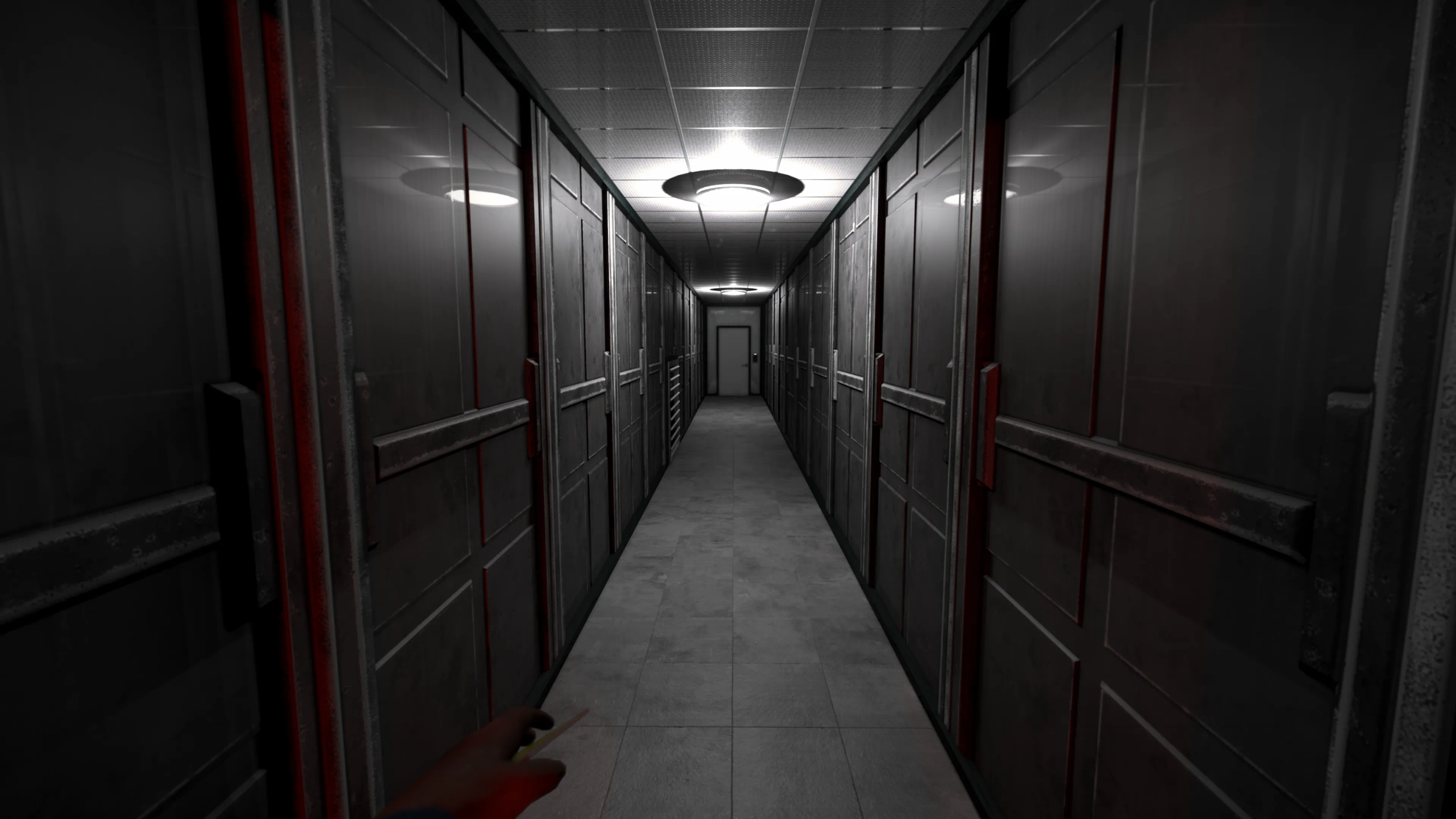 A corridor of heavy steel doors marked in red, stretching toward a single exit